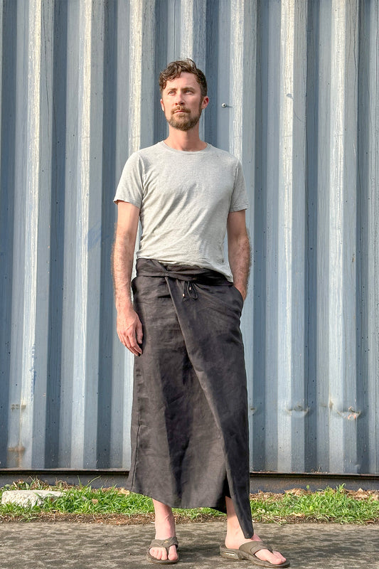 Short black linen sarong for men with deep pockets and sustainable design.