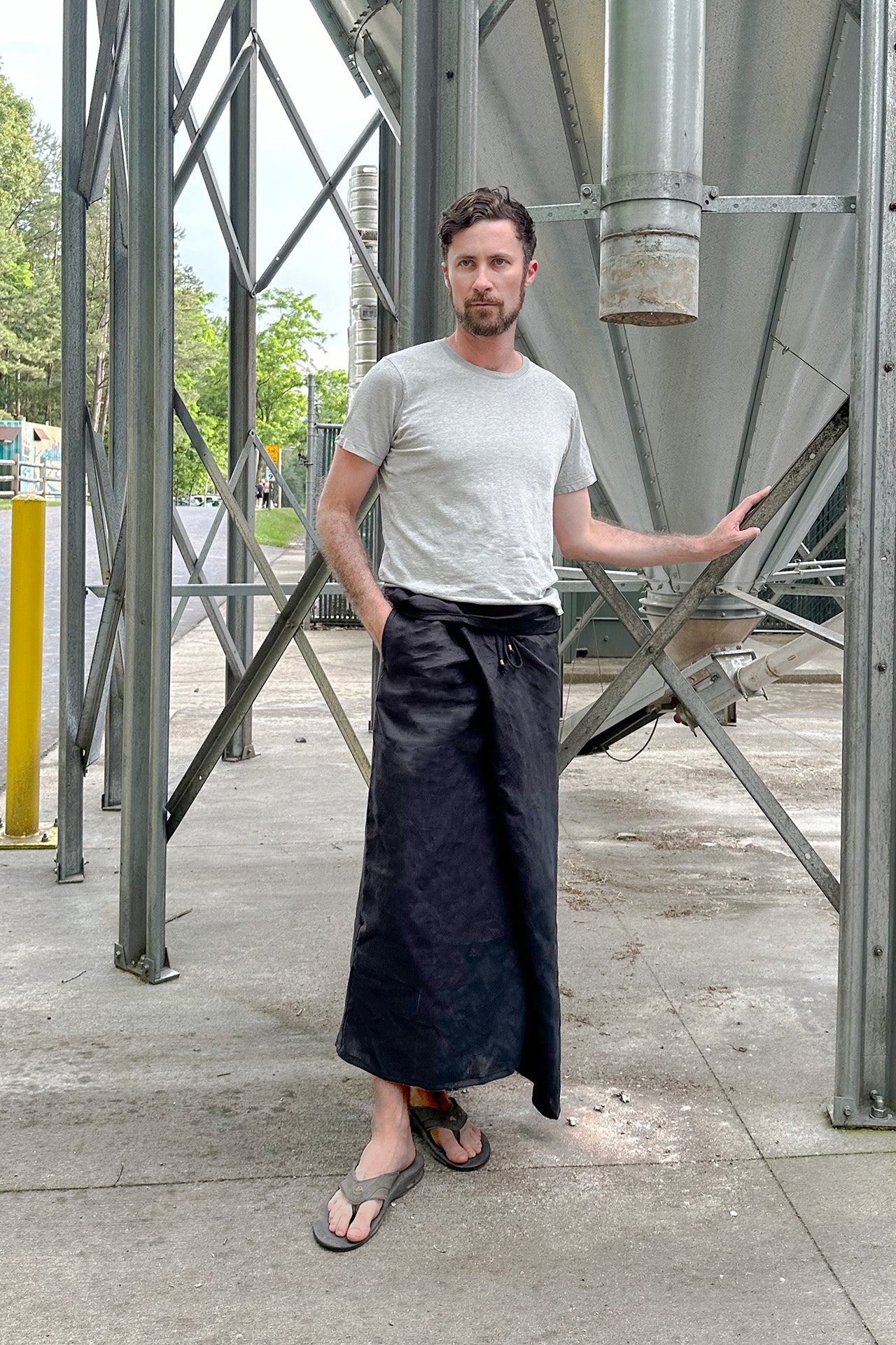 Short black linen sarong for men with deep pockets and sustainable design.
